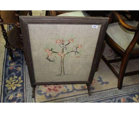 An embroidered firescreen depicting birds in a tree, 22" wide x 31" high.