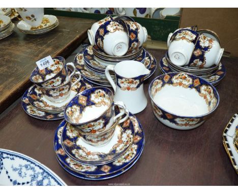 A Royal Albert part tea service in blue, orange, white and gilt to include; twelve cups, eleven saucers, twelve tea plates, t