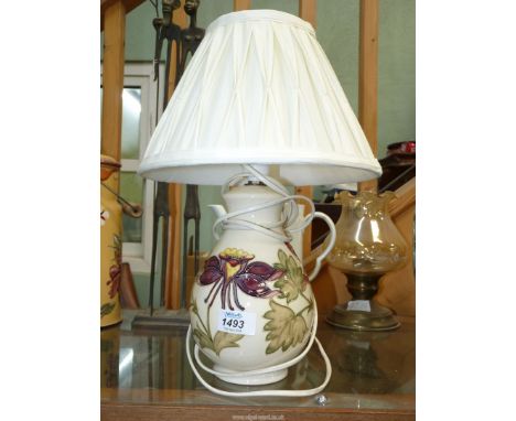 A Moorcroft table lamp in Columbine pattern, 15" tall including shade.