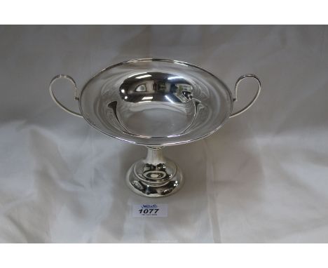 An Aspreys Arts & Crafts Silver Tazza with wide deep loop handles standing on circular step base and knop to stem, 9" long x 