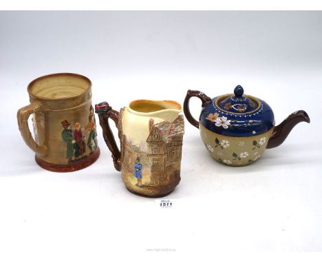 A Royal Doulton tankard and jug (Oliver Twist and Sairey Gamp) and a Langley's Lambeth style teapot.