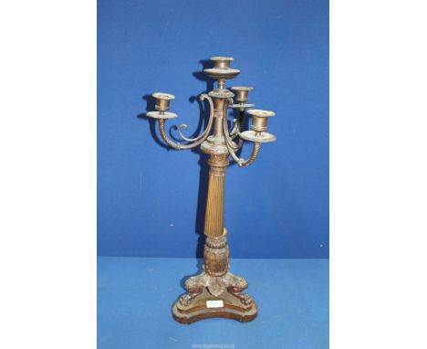 A heavy bronze metal four light Candelabrum having a tapering reeded column, swept sconce supports, the base a foliage detail