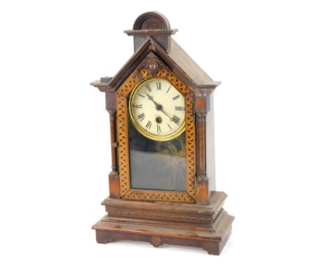 A late 19thC marquetry inlaid mantel clock, the arched and domed top with a parquetry panel, on Roman numeric ceramic dial, t