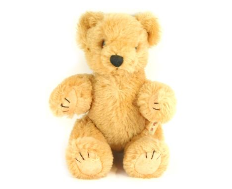 A Japanese pure wool plush blonde jointed Teddy Bear, bearing label, 20cm high.