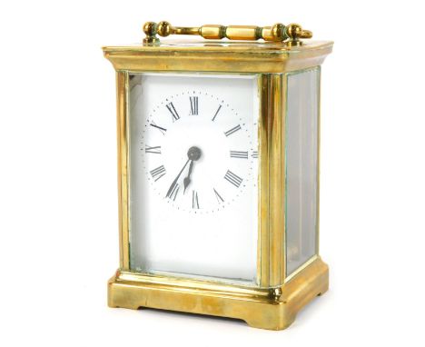 A 20thC brass carriage clock, of rectangular form, with a white enamel Roman numeric dial, in a brass case with open work mov