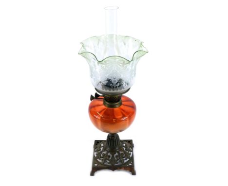 A Victorian oil lamp, with a cranberry glass reservoir and an etched and green glass flared shade, 45cm high.  