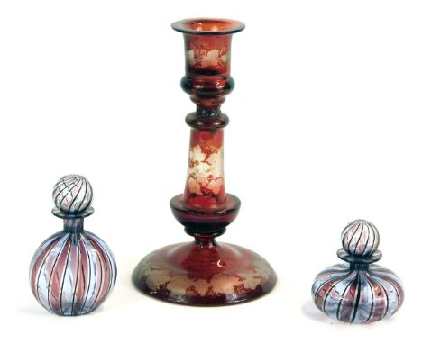 A group of glass ware, comprising a ruby flashed glass candlestick, with grape vine detail, 20cm high, and two banded scent b