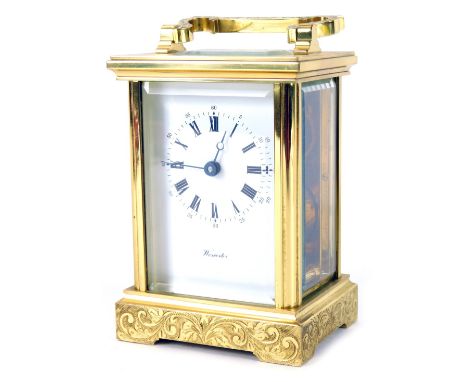 A 20thC brass carriage clock, with white Roman numeric dial, with key wind marked Worcester, with openwork movement, and scro