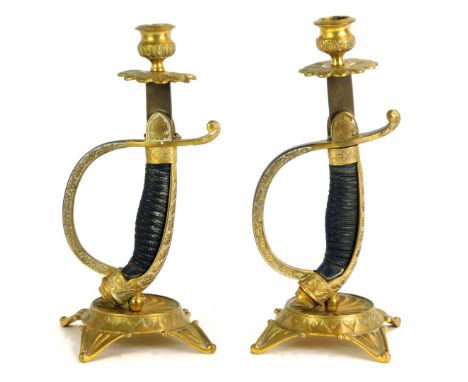 A pair of WWI German sword hilt candle holders, the column formed as a dagger in scabbard, with star base with petalated top,