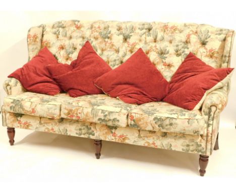 A button back sofa, in a hunting scene upholstery, on mahogany legs, 120cm high, 193cm wide, 65cm deep.