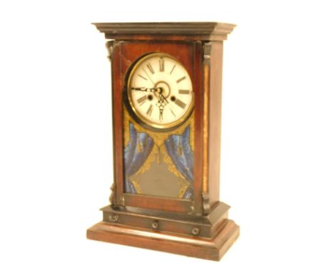 A late 19thC mahogany and ebonised cased mantel clock, with a white Roman numeric dial, in brass casing with a blue curtain f