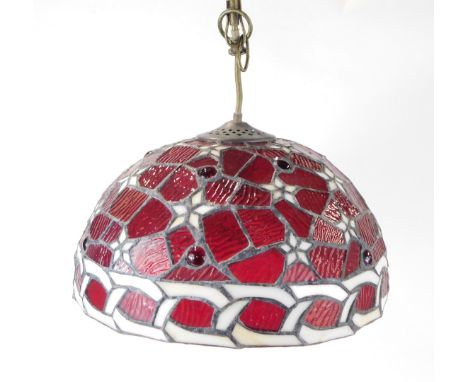 A Tiffany style light shade, on red paneled ground, with star design, 26cm diameter.