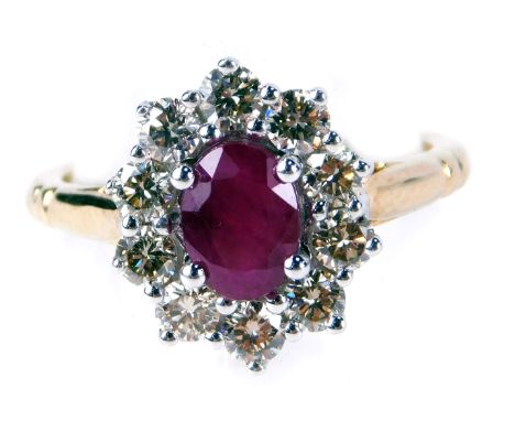 A ruby and diamond cluster ring, with an oval cut ruby, totaling approx 0.80cts, in four claw setting, surround by round bril