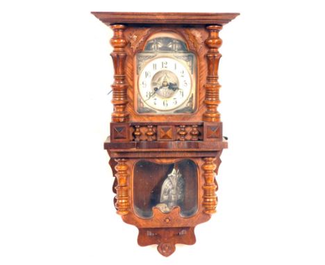 An Art Nouveau Indacta oak wall clock, with carved column and leaf supports, with applied art nouveau style swag cresting and
