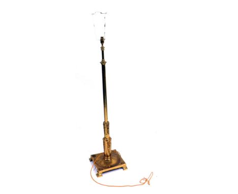 A brass standard lamp, with Neoclassical swag design, on bracket feet, 115cm high, with later shade. (AF)WARNING! This lot co