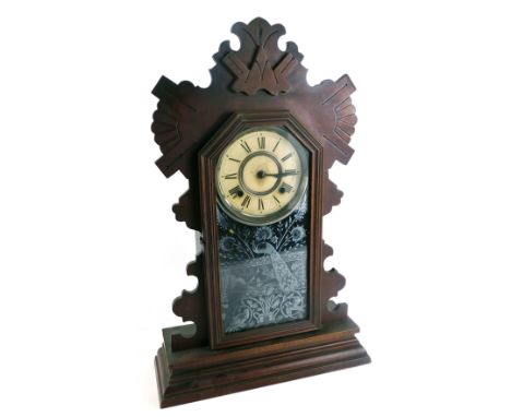 A late 19thC Ansonia Clock Company mantel clock, with a fluted and carved top, with single glazed panel door, depicting peaco