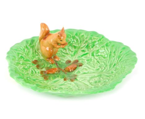A Carltonware squirrel nut bowl, of cabbage leaf form with applied squirrel, 23cm diameter. (AF) 
