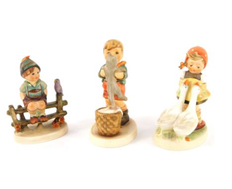 Three Goebel by Hummel figures, comprising Goose Girl, 11cm high, Wayside Harmony, 10cm high, and Kitty Kisses, 11cm high. (3