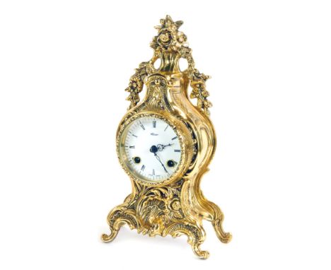 A Mozer brass mantel clock, enamel dial, eight day movement, with a floral swag top, of rococo scroll out splayed feet, 33cm 