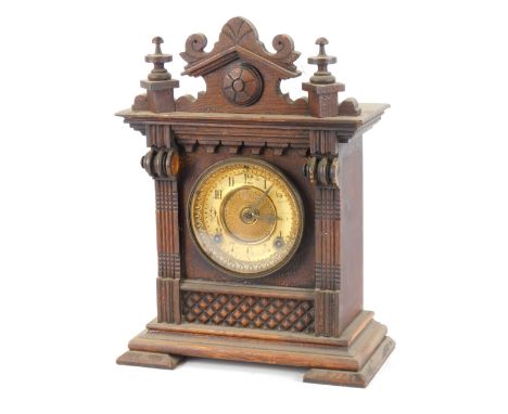A late 19thC Ansonia Clock Company oak cased mantel clock, with a moulded cornice top, on reeded supports with a gilt numeric