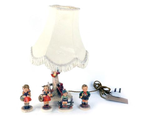 A group of Goebel by Hummel figures, comprising a table lamp of a child on tree trunk with dog, with cream shade, 48cm high, 