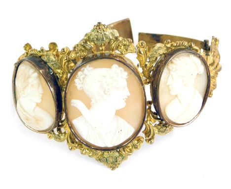 A late 19thC/early 20thC shell cameo bracelet, formed with three oval cameos depicting maidens in flowing headdress, in a gil