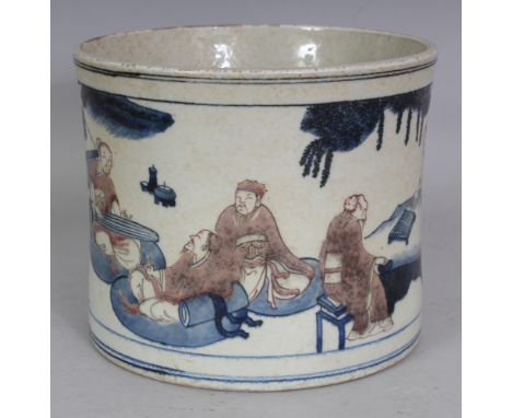 A LARGE CHINESE COPPER-RED & UNDERGLAZE-BLUE PORCELAIN BRUSHPOT, the waisted sides decorated with panels of sages and of offi