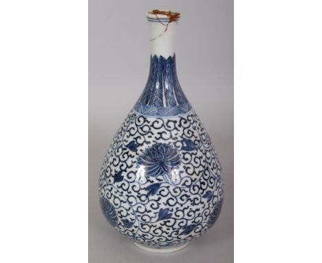 A 19TH CENTURY CHINESE KANGXI STYLE BLUE & WHITE PORCELAIN BOTTLE VASE, painted with formal scrolling lotus, the base with a 