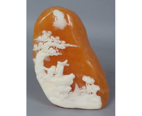 A CHINESE SHOUSHAN STYLE STONE BOULDER, decorated in white reserve relief against an amber coloured ground with a sage and hi