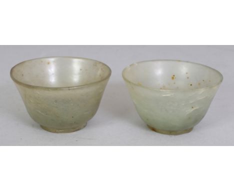 A SMALL PAIR OF 20TH CENTURY JADE WINE CUPS, the celadon green stone with speckled black inclusions, 2.1in diameter & 1.2in h