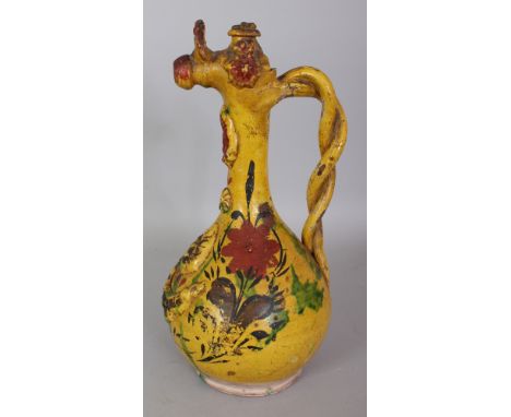 A 19TH CENTURY TURKISH OTTOMAN CANAKKALE GLAZED CERAMIC EWER, with moulded and painted floral decoration reserved on a yellow