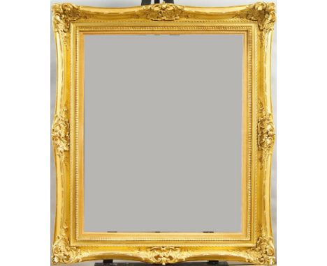 A Gilded Composition Louis XV Style Double Swept and Pierced Frame, late 20th century, with rais-de-coeur sight, plain hollow