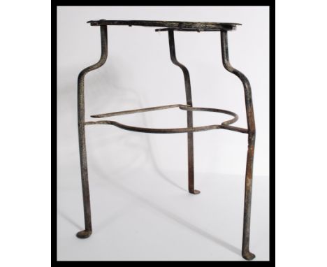An 18th century Georgian fretwork brass and steel trivet stand raised on shaped tripod stand. Measures 32 cm high.