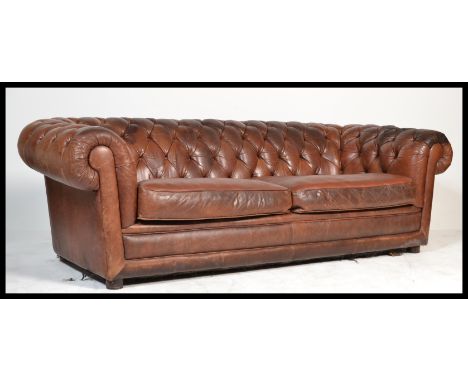 A good brown leather Chesterfield sofa settee of large size having button backed upholstery, 2 large cushions centre raised o