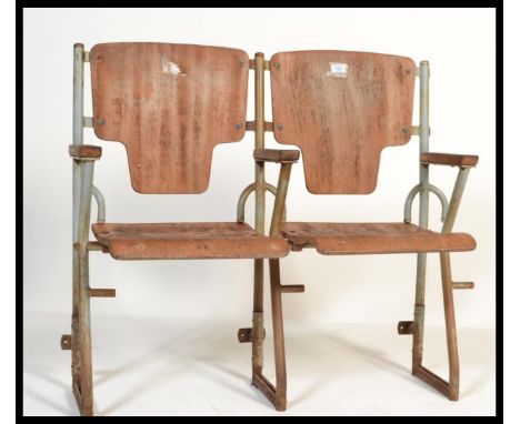 A pair of vintage Industrial mid&nbsp; 20th century cinema - theatre chairs. Set on a metal tubular frame having wooden arm r