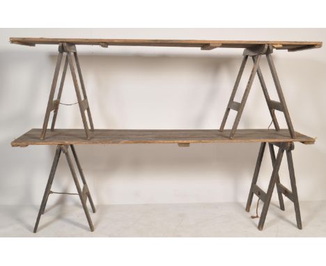 A pair of vintage retro 20th century trestle table tops raised on two sets of folding trestle&nbsp; table legs. Each piece ha