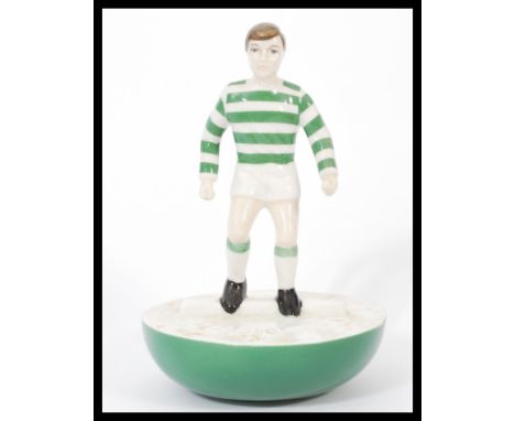 A Royal Doulton Subbuteo ceramic football figurine MCL 12 featuring a player in green and white stripped kit on green and whi