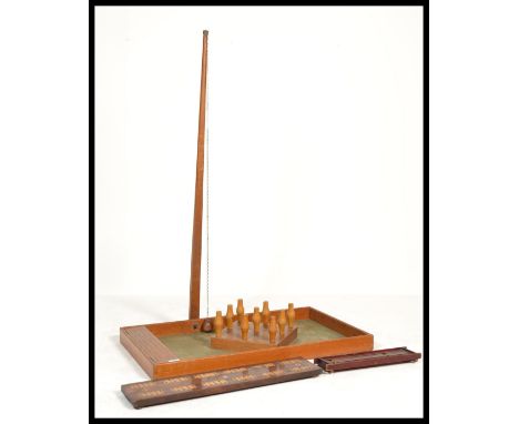 A vintage large mid century bar skittles game complete with skittles, table, scoring board, arm and chain with ball and also&