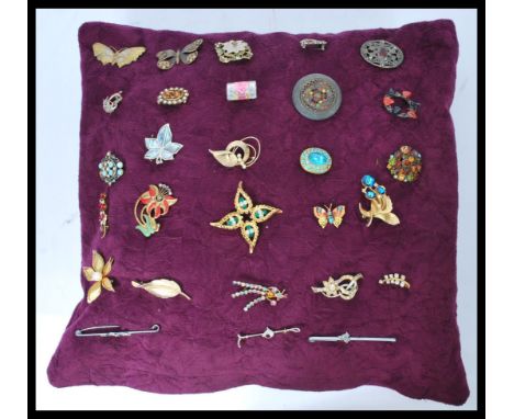 A collection of costume jewellery brooches to include yellow metal examples. enamel painted, stone set and many more