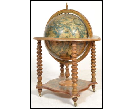 An antique style cocktail drinks cabinet in the form of a globe with hinged top section to fitted interior. 