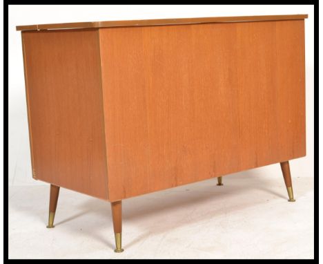 A vintage retro 20th century teak wood blanket box storage chest raised on retro tapering legs with brass disk feet. Hinged l