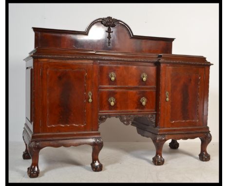 An Edwardian mahogany inverted breakfront Chippendale revival sideboard. Raised on cabriole legs with claw and ball feet with