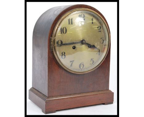 An Edwardian mahogany spire cased mantel clock with silvered dial and an inset 8 day brass movement with key and pendulum.&nb