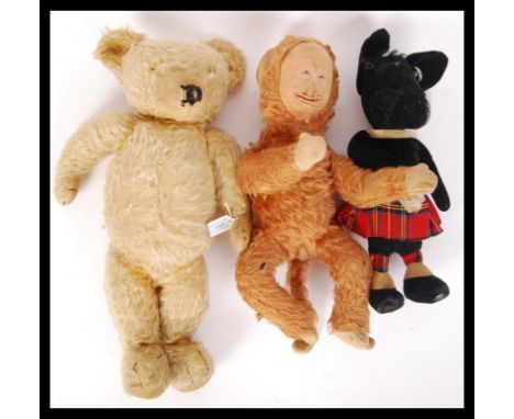 An original vintage Merrythought Toys made teddy bear with jointed arms , legs and head having makers button to ear along wit