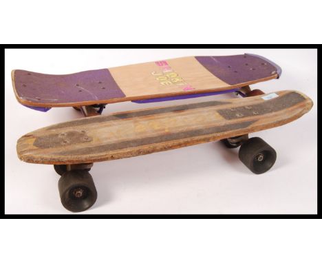 Two retro vintage skateboards one being a Smokin' Joe deck having a plywood and grip tape deck with metal trucks and rubber w