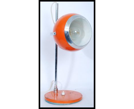 A vintage retro 20th century eye ball spot lamp raised on a circular base with adjustable tubular supports. Finished in a vib