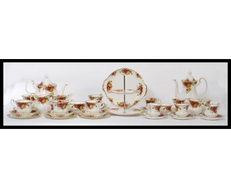 Royal Albert bone China tea and coffee service in the Country Roses pattern, first issue to include Coffee pot, teapot, trio'