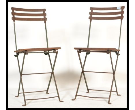 A pair of vintage retro 20th century metal folding lawn bistro chairs having slatted wooden seats.&nbsp;Measures: 86cm high x