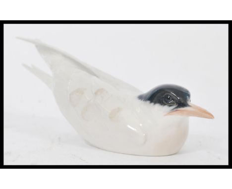 A Royal Copenhagen ceramic figurine of a Tern stamped to the base 827 entitled Arctic Tern. Makers stamp to base. Measures 26