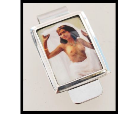 A contemporary novelty sterling silver money clip featuring an enamel panel including a portrait of a semi nude model.&nbsp;&